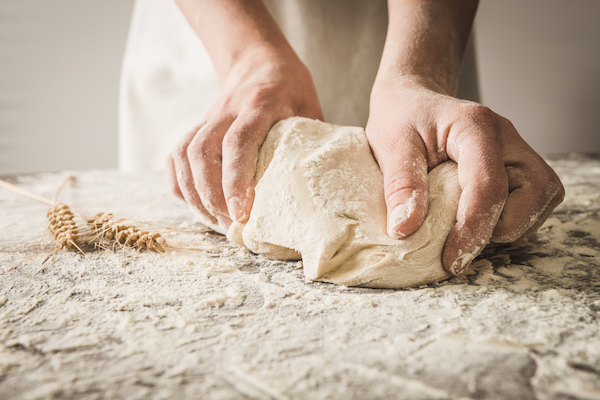 hands rumple dough